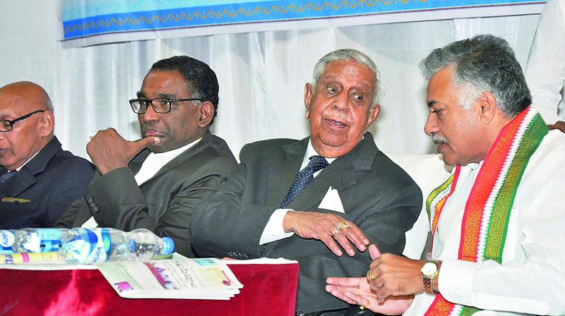 Former Chief Justice of Supreme Court, Justice M.N. Venkatachalaiah has a word with former RS member Dr Yarlagadda Laxmi Prasad as Supreme Court Judge Justice J. Chalasmeswar looks on during  the endowment lecture on former Prime Minister P.V. Narasimha Rao at AU Assembly Hall in Visakhapatnam on Saturday. (Photo: DC)