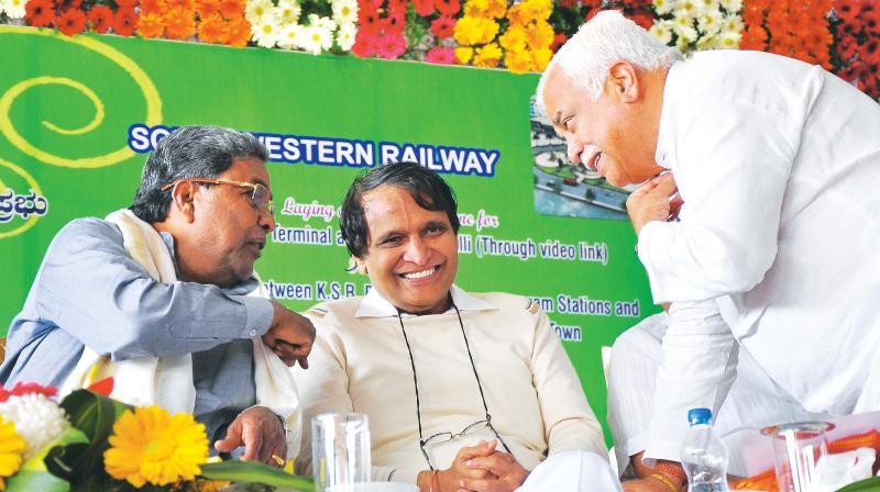 Chief Minister Siddaramaiah (from L), Railway Minister Suresh Prabhu and Minister for Industries R.V. Deshpande at the inauguration of Main Line Electric Multiple Unit (MEMU) service between Bengaluru and Ramanagara, in Bengaluru on Monday (Photo: Satish B.)