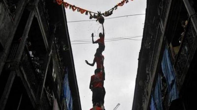 Dahi-Handi ritual is part of the Janmashtami festival in which youngsters, dressed in colourful costumes, make human pyramid to reach earthen pot having buttermilk, suspended in mid-air and break it. (Photo: ANI)