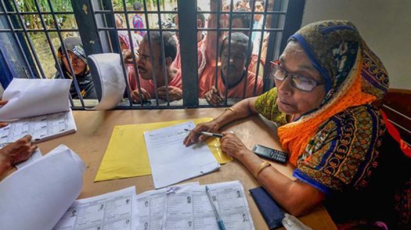 People wait in a queue to check their names on the final draft of the states National Register of Citizens after it was released, at an NRC Seva Kendra, in Morigaon. (Photo: PTI)