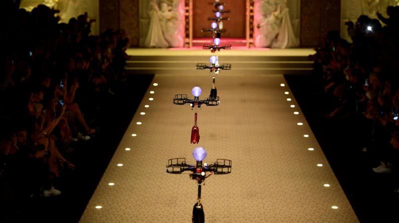 Drones carrying handbags fly over the stage during the womens Fall/Winter 2018/2019 collection fashion show by Dolce & Gabbana in Milan, on February 25, 2018. (Photo: AFP)