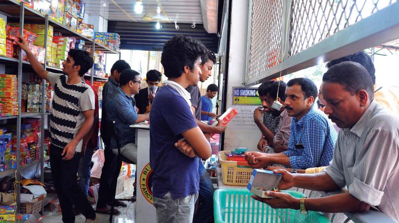 Customers check out crackers at Ayyans store on Koya Road in Kozhikode on Tuesday.