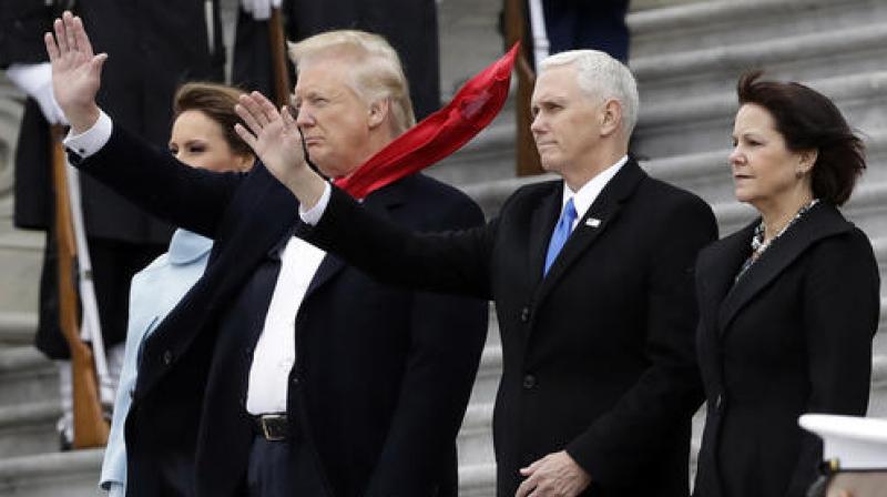 President Donald Trump and first lady Melania Trump along with Vice President Mike Pence and his wife Karen wave to former President Barack Obama during a departure ceremony on the East Front of the U.S. Capitol in Washington. (Photo: AP)