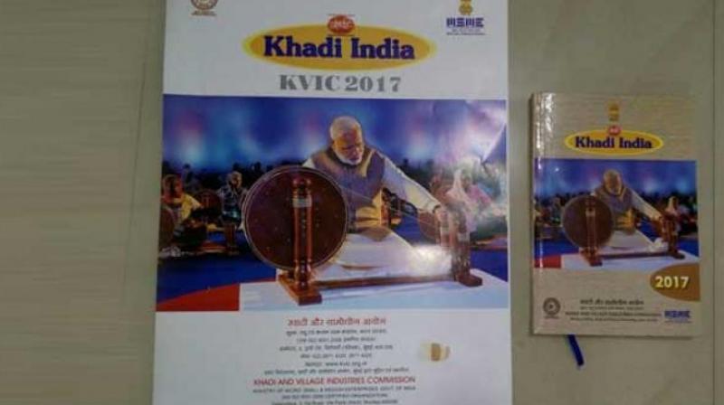 PM Narendra Modi spinning the charkha on the 2017 KVIC calendar. (Photo: Twitter)