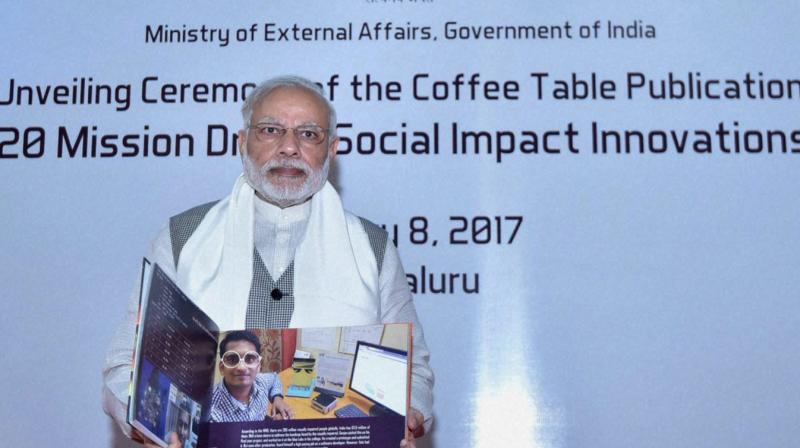 Prime Minister Narendra Modi releasing the Coffee Table book  20 Mission Driven Social Impact Innovations  at the Pravasi Bharatiya Divas (PBD-2017) Exhibition Center in Bengaluru, Karnataka. (Photo: PTI)