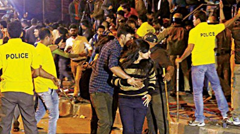 A woman protects herself against the mob on New Years Eve in Bengaluru.