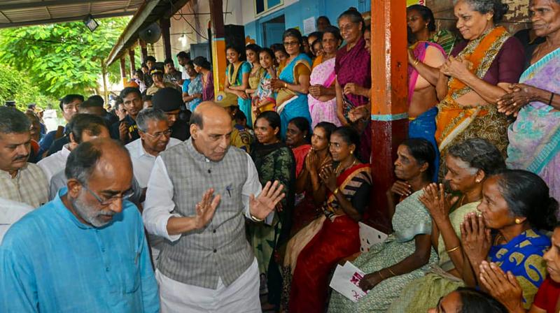 Union Home Minister Rajnath Singh interacts with flood affected people at Elanthikkara relief center in Ernakulam on Sunday. Kerala CM Pinarayi Vijayan and Union Minister KJ Alphons are also seen. (Photo: PTI)