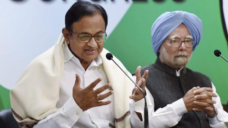 Former Finance Minister P Chidambaram with former PM Manmohan Singh speaks to media after release The REAL State of Economy Report- 2017 at AICC in New Delhi on Monday. (Photo: AP)