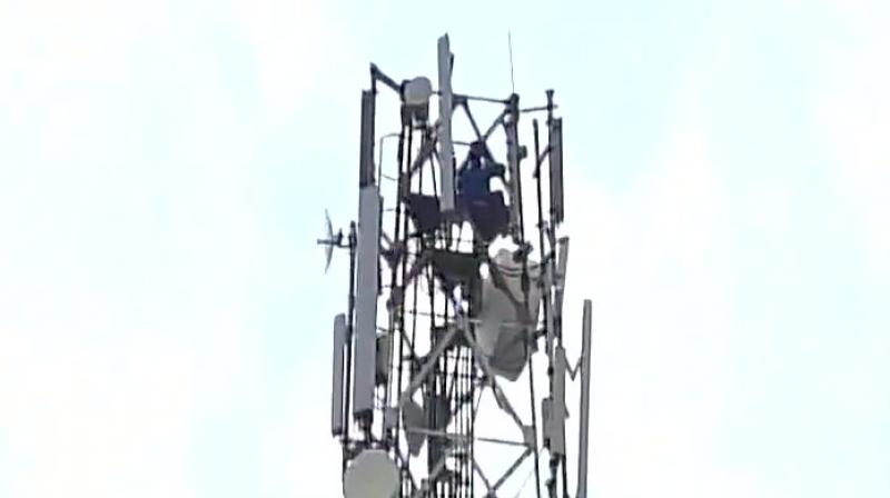 The man sent the whole town into a state of frenzy as he remained perched on the tower for four hours. (Photo: ANI | Twitter)