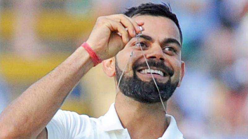 India captain Virat Kohli displays his wedding ring after scoring a century against England during the second day of the first Test at Edgbaston in Birmingham.