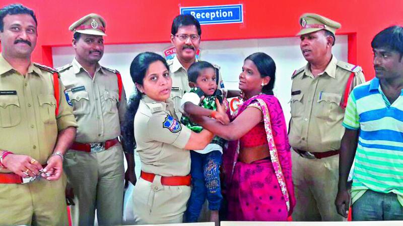 P.V. Padmaja, DCP, Shamshabad, handing over the child to his parents.  	(Photo:DC)