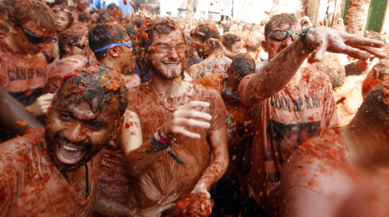 Revelers throw tomatoes at each other, during the annual \Tomatina\, tomato fight fiesta, in the village of Bunol, 50 kilometers outside Valencia, Spain. (Photo: AP)