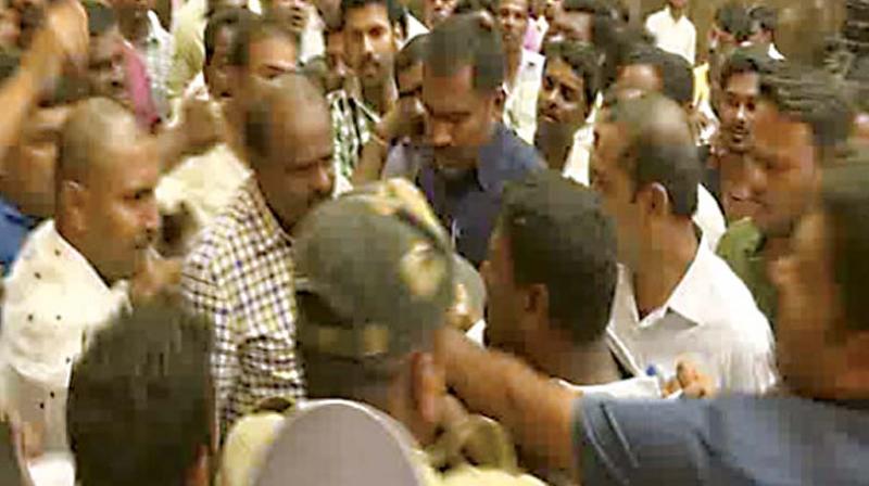 JD(S) leader H.D. Kumaraswamy with a group of party workers during which he allegedly slapped a supporter