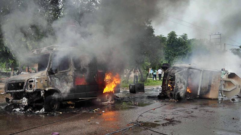 Vehicles burn in violence following Dera Sacha Sauda chief Gurmeet Ram Rahims conviction in Panchkula on Friday. (Photo: PTI)