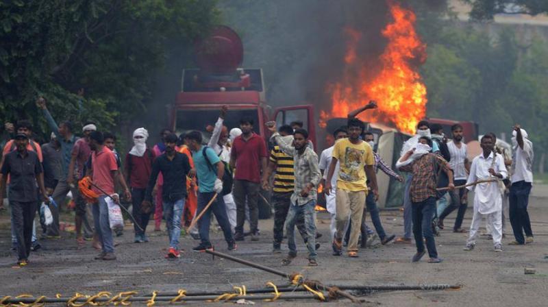 The agitating Dera followers on Friday resorted to damaging public and private properties as well as attacking mediapersons. (Photo: AFP)
