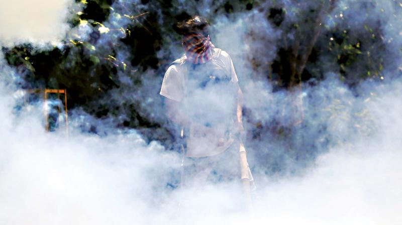 A student amid teargas smoke in Srinagar on Monday. (Photo: AP)