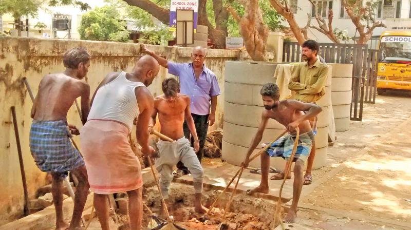 Men constructing recharge wells where rainwater can be collected. (Photo: DC)
