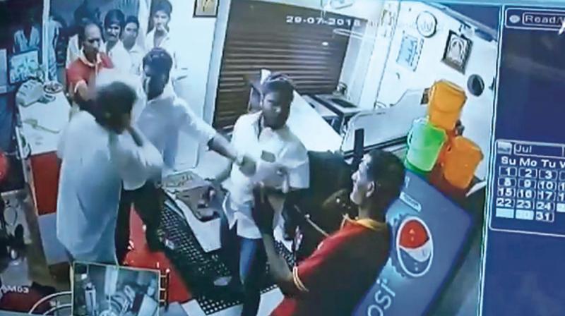CCTV grab shows biriyani stall staff being attacked.