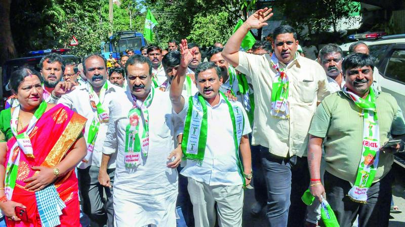 JDS workers protest in front of BJP MLA Ashwath Narayanas residence over his alleged attempts to destablise the government, in Bengaluru, Wednesday.	 (PTI)