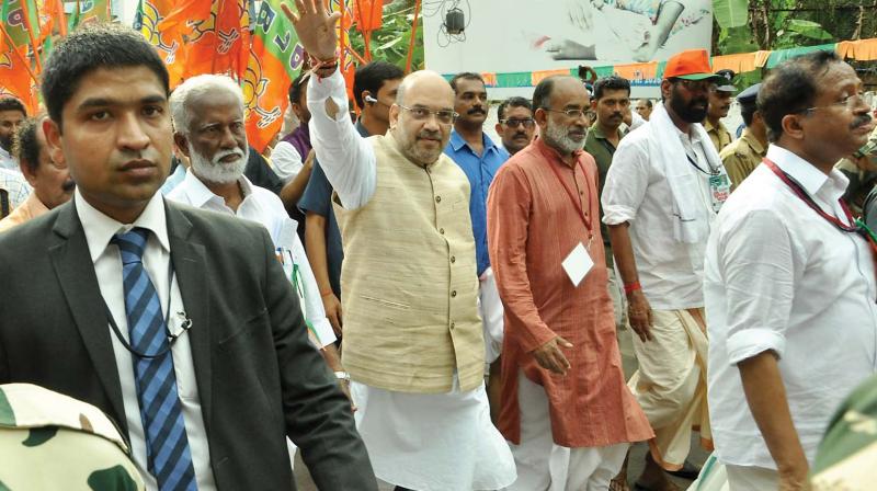 BJP president Amit Shah walks during the partys Janaraksha Yatra in Payyannur on Tuesday. Union minister Alphons Kannanthanam and BJP state president Kummanam Rajasekharan are also seen. (Photo: Venugopal)