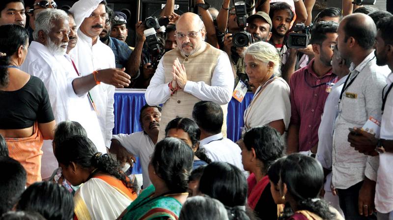 BJP national president Amit Shah greets relatives of RSS, BJP workers who were killed allegedly by political opponents in Payyannur on Tuesday at the inauguration  venue of Janaraksha Yatra. 	(Photo: VENUGOPAL)