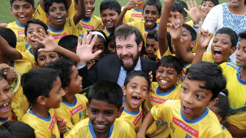 Rio Santos Rocha Camargo, sports and cultural section in-charge at Embassy of Brazil, poses with children of Kerala Blasters Soccer School in Kochi on Thursday. 	 ARUN CHANDRABOSE