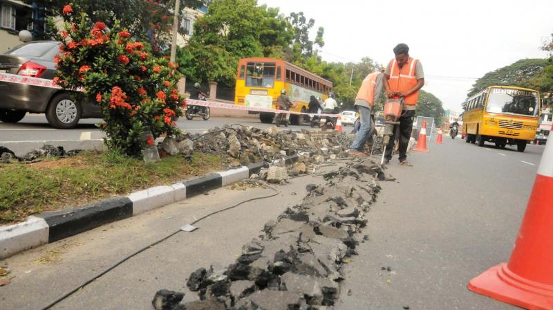 TRDCL workers drill road near Asan Square at Palayalam on Thursday. 	DC