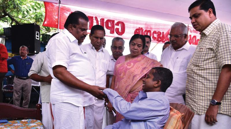 CPM leader E.P. Jayarajan interacts with a victim of BJP violence during the gathering of the families of 65 Left workers killed and the living victims of the same at Stadium corner in Kannur on Monday.	(Photo: DC)
