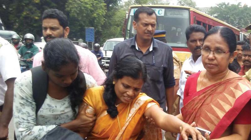 Health minister K.K. Shylaja helps K Devikarani, an accident victim, get into her escort vehicle to be taken to General Hospital.