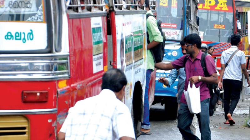 Commuters board a private bus in Kochi. (Photo: DC)
