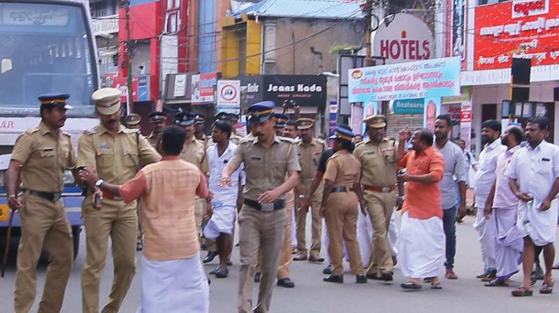 Policemen push aside UDF activists who blocked KSRTC buses at Swaraj Round in Thrissur on Monday. 	 DC