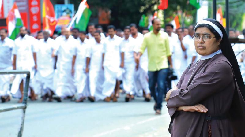 A nun waits for vehicle even as the UDF activists conduct a march during the hartal day on Monday. A scene from Banerji road near Saritha theatre here.	(Photo: ARUN CHANDRABOSE)