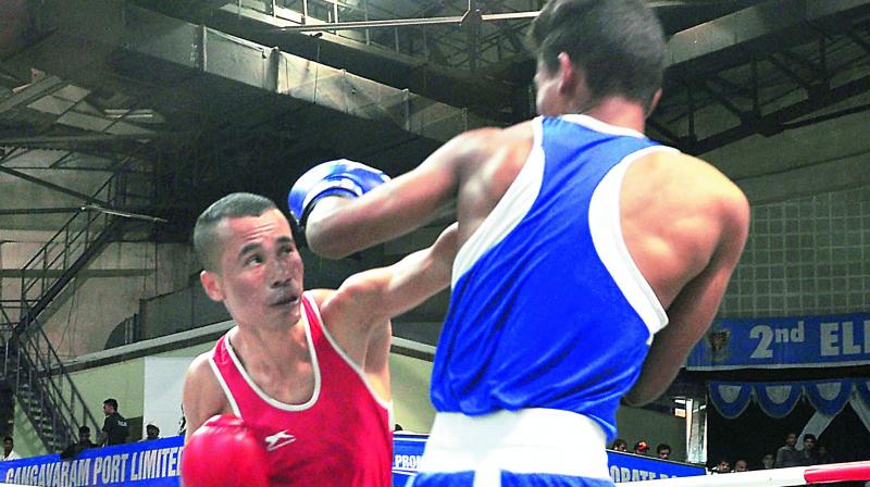 Aditya Kumar (blue) of Bihar bouts on Boni Sharma of Trivandram during the 2nd Elite Mens National Boxing Championships at Swarna Bharathi Indoor Stadium in Visakhapatnam on Tuesday. (Photo: Deccan Chronicle)