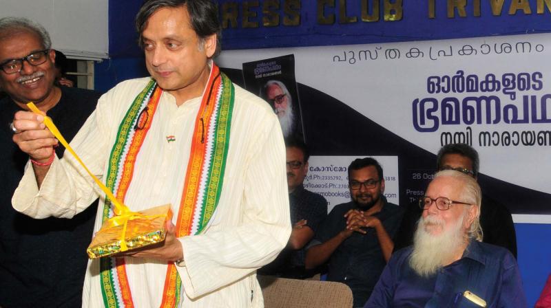 Congress MP Shashi Tharoor releases the autobiography of former ISRO scientist and head of cryogenics division Nambi Naryanan (seated) in Thiruvananthapuram on Thursday. 	(Photo: A.V. MUZAFAR)