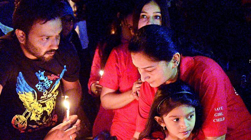 People light candles in the city on Sunday in support of cross-country biker Sana Iqbal who was killed in an alleged car accident last week. (Photo: DC)