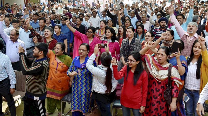 Bank employees shouting slogans during their one day strike for various demands, at Jantar Mantar in New Delhi on Tuesday. (Photo: PTI)