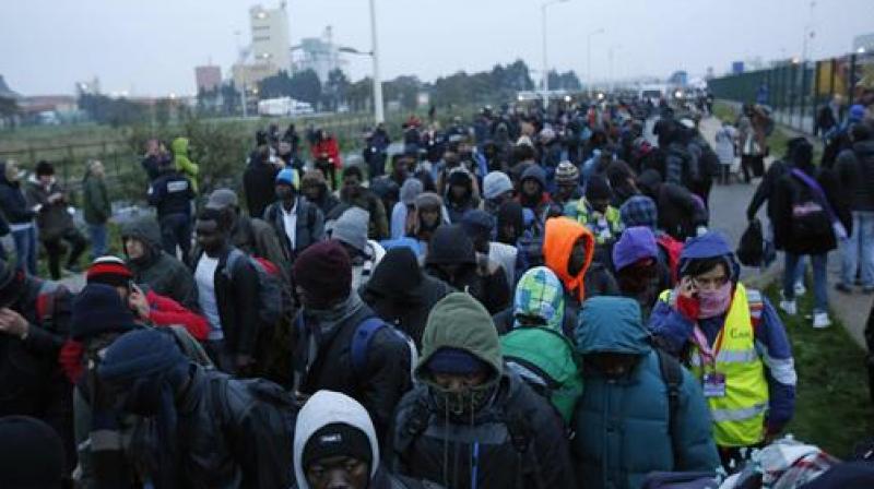 Migrants line-up to register at a processing centre in the makeshift migrant camp known as the jungle near Calais, northern France. (Photo: AP)