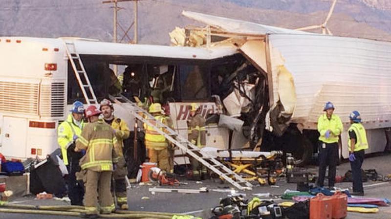 Emergency personnel work the scene where a tour bus crashed into the rear of a semi-truck on westbound Interstate 10, just north of the desert resort town of Palm Springs in Desert Hot Springs. (Photo: AP)