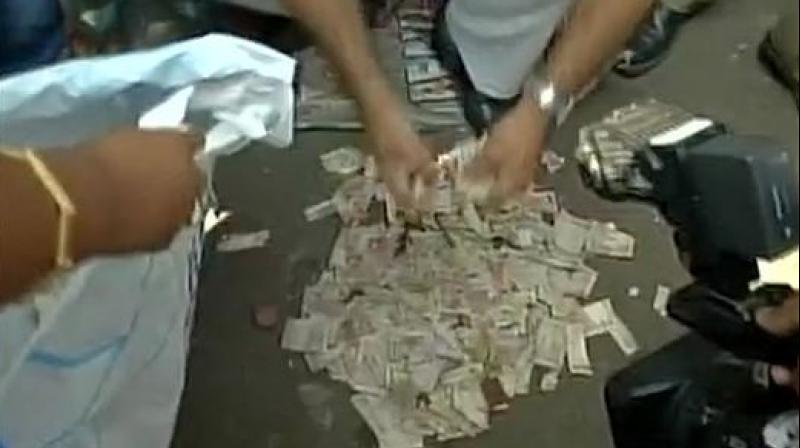 Two sack-full of torn and damaged currency notes of Rs 500 and Rs 1000 were recovered from a garbage vat in Kolkata on Sunday. (Photo: ANI/Twitter)