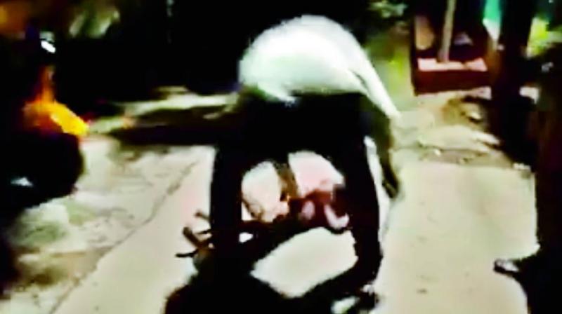 Screenshot of a video that shows the man hitting his sons head on the ground.