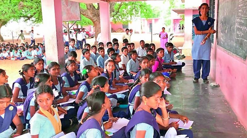 Thirteen-year-old K. Srija teaching other school children.