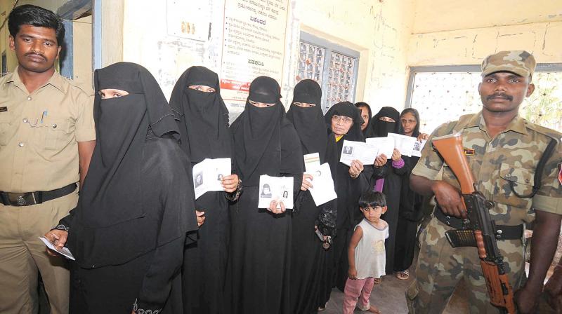 Women cast their votes at a booth in Nanjangud constituency on Sunday. (Photo: KPN)