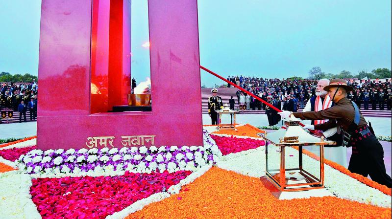 Prime Minister Narendra Modi lights the eternal fire at the National War Memorial after the interfaith prayers, during its inauguration ceremony at the India Gate complex in New Delhi, on Monday. (Photo: AP)