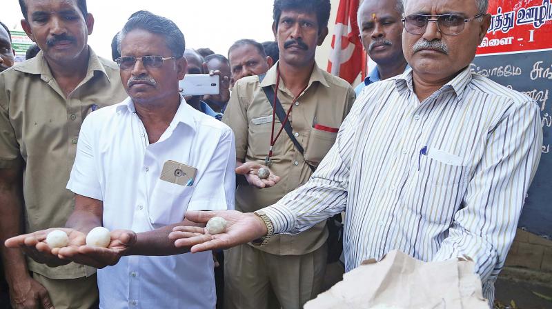 Transport workers show cooked plastic rice supplied to them at Sungam bus depot mess in Coimbatore on Wednesday. (Photo: DC)