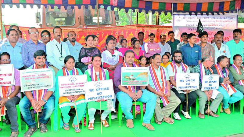 Employees of DCI display placards as they stage a relay-hunger strike protesting privatisation near Sea Horse Junction in Vizag on Tuesday. (Photo: DC)