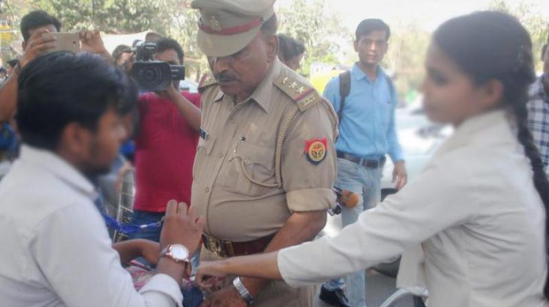 Anti-Romeo squad of police hauls up a youth in Lucknow on Wednesday. \Anti-Romeo squads\ ordered by new Chief Minister of Uttar Pradesh, Yogi Adityanath have started work across the state. (Photo: PTI)