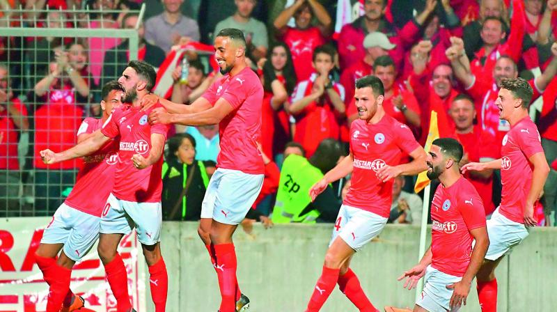 Nimes players celebrate a goal during their French Ligue 2 football match against Ajaccios at the les Costieres Stadium in Nimes on Friday. Nimes won 4-0. (Photo: