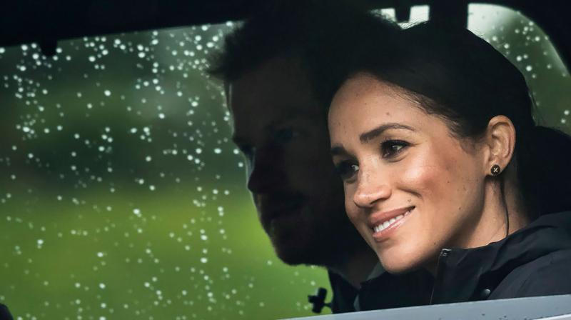 Britains Prince Harry and his wife Meghan, Duchess of Sussex arrive for the unveiling of a plaque dedicating 20 hectares of native bush to the Queens Commonwealth Canopy project at The North Shore Riding Club in Auckland on October 30, 2018. (Photo: AFP)
