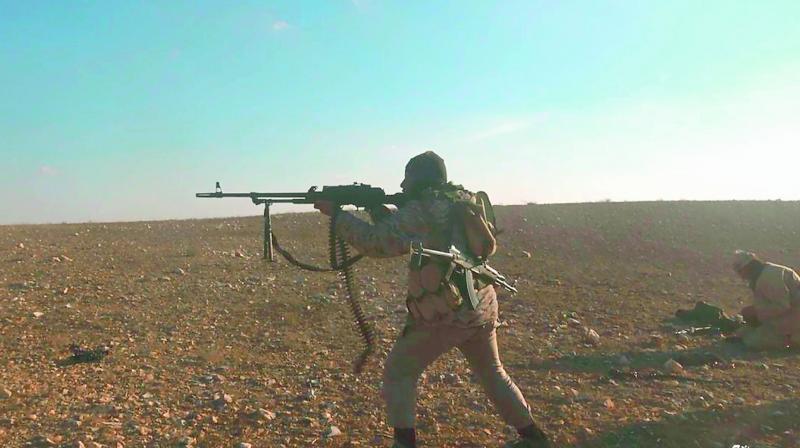 A gunman fires at an unseen target, east of of Palmyra. (Photo: AP)