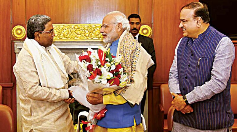 Chief Minister Siddaramaiah greets Prime Minister Narendra Modi in New Delhi on Friday.
